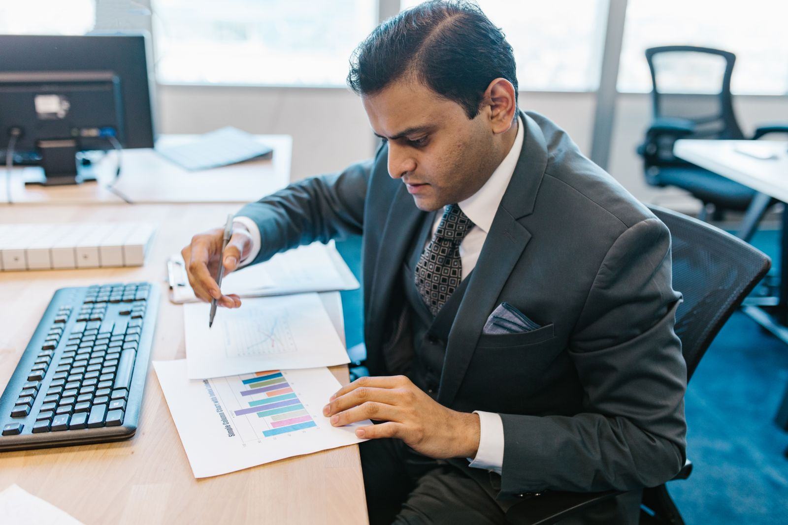 An advocate reviewing papers at a desk