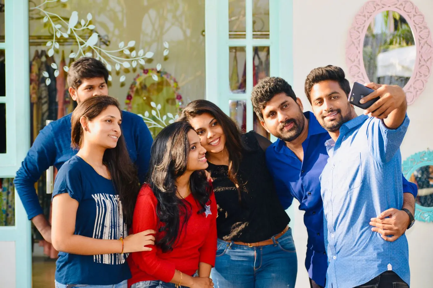 A group of young friends taking a selfie together outdoors